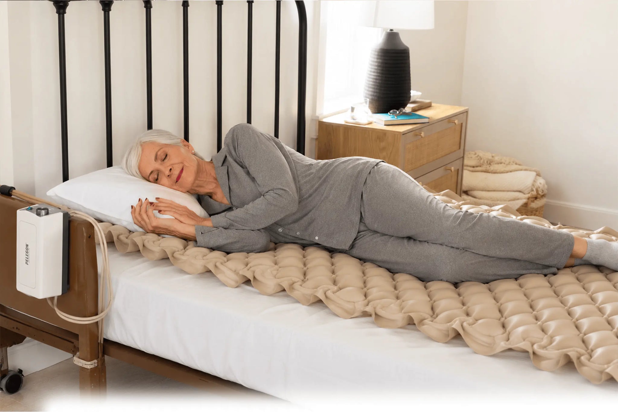 Older adult using an alternating air pressure mattress for comfort and pressure relief.