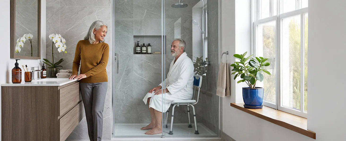 Senior man using a shower chair in a walk-in shower while maintaining safe and independent bathing at home.